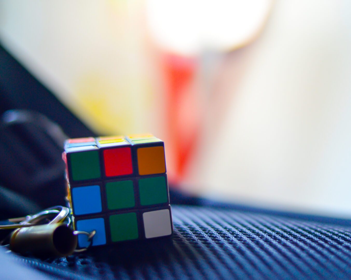 Puzzle cube resting on textured surface