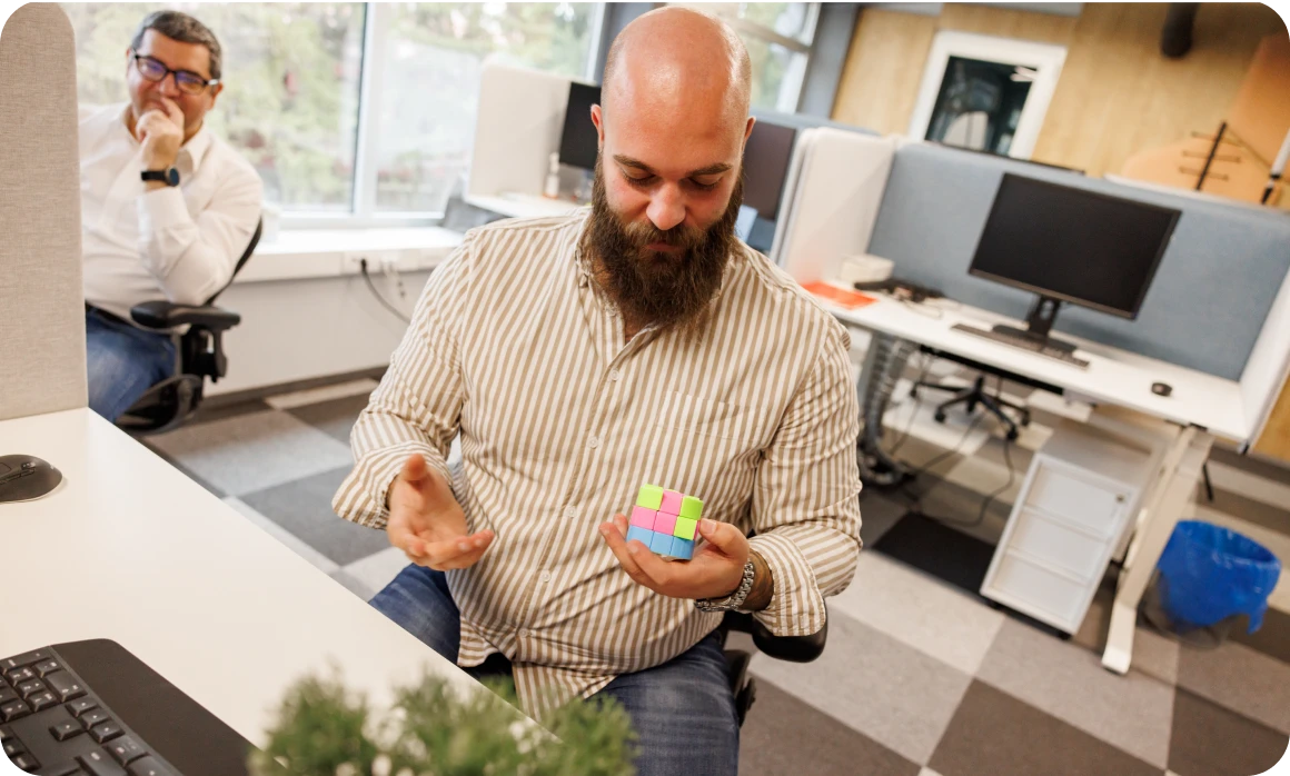 Office worker playing with colorful cube