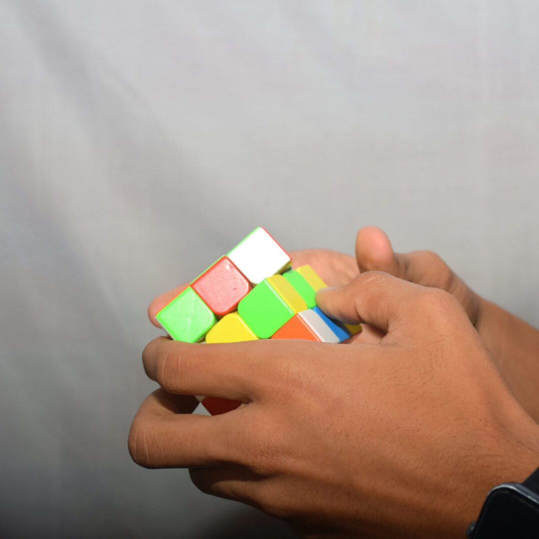 Person manipulating Rubik's Cube puzzle